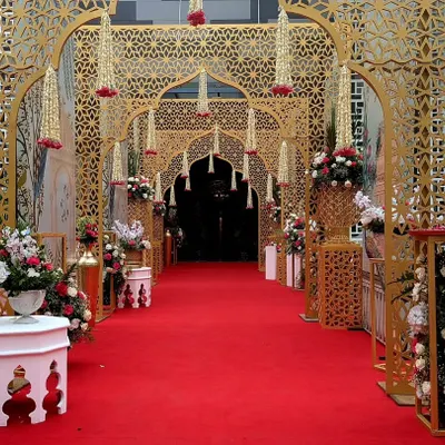 I designed this majestic entrance using a series of golden jaali arches, creating a royal passageway for guests. The intricate patterns and hanging floral tassels guide the eye, building a sense of grandeur and traditional opulence.