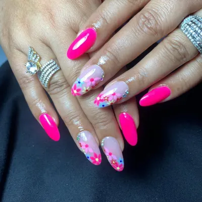 A vibrant, glossy hot pink set with accent nails featuring delicate, hand-painted flowers.
