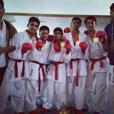 This is the result of teamwork and shared dedication. My sub-junior team proudly displays their gold medals after winning the team Kumite event. We fight together and we win together.