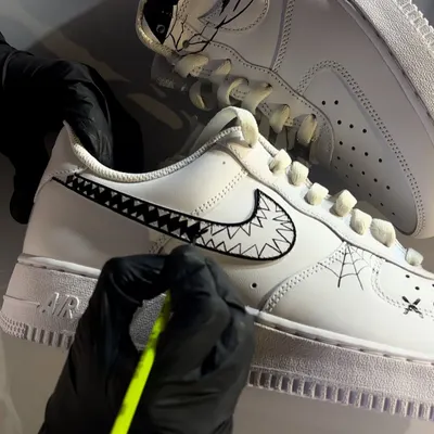 A close-up, behind-the-scenes shot of me hand-painting the fine details on a Halloween-themed custom sneaker.