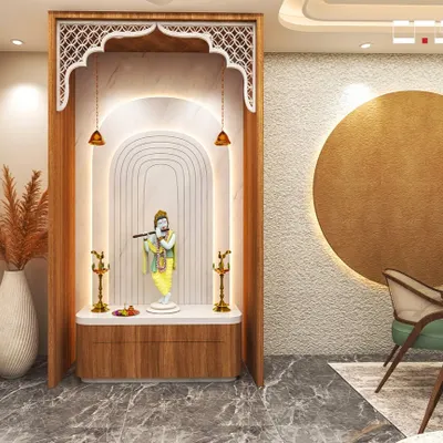 This elegant pooja room concept features a beautiful arch with traditional jaali work, soft backlighting, and a marble platform for the deity. The design is serene, spiritual, and seamlessly integrated into the home.