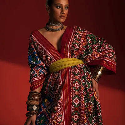 Here, I've styled a traditional Patola-inspired kaftan from Ravissant, blending heritage textiles with a modern silhouette. The rich colors and patterns are balanced with a contemporary waist belt and minimal accessories to create a striking, culturally relevant fashion statement.