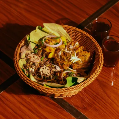 My Manipuriness Relish Munch basket, featuring a mix of Singju, Bora, and other snacks, served with traditional black tea (Cha-ngang).