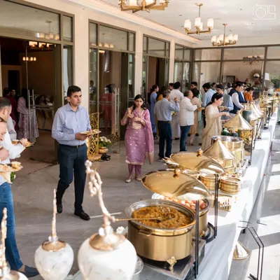Guests enjoying a seamless buffet experience at an elegant indoor event. My setups are designed for easy flow, ensuring everyone can comfortably enjoy the wide array of dishes offered.