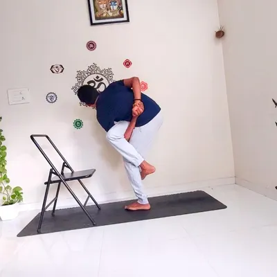 Chair yoga is a fundamental part of my corporate offering, making the practice accessible to everyone. This pose, an adaptation of Revolved Bird of Paradise, uses a simple office chair for support to build core strength, improve balance, and open the hips without needing a yoga mat.