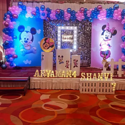 A full view of our Mickey and Minnie Mouse birthday stage setup. We combine printed backdrops, a shimmering sequin wall, and custom light-up names to create a focal point for the celebration.