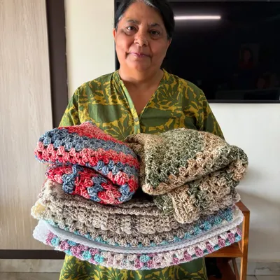 This is me, Nishtha, with a stack of freshly finished blankets. Every order we pack is filled with the same excitement and happiness as our very first one.