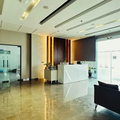 A wide-angle view of the M/s ALP office lobby, showcasing the spacious layout that ensures a smooth flow of traffic. The design connects the reception desk, waiting area, and entry to the main office seamlessly.