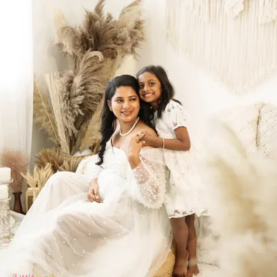 A serene and beautiful moment between a mother and her daughter. This boho-themed maternity shoot uses soft, natural textures and lighting to create a peaceful and loving atmosphere.