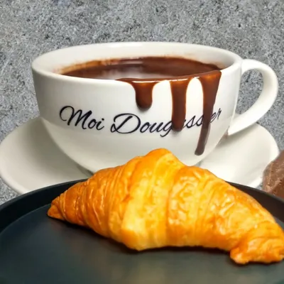 The ultimate indulgence. A cup of my signature thick, velvety hot chocolate, overflowing with richness, served with a classic butter croissant perfect for dipping.