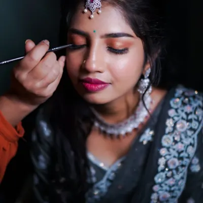 A close-up of the eye makeup application. I take great care in the details, from blending eyeshadows to applying eyeliner, to create a look that makes your eyes pop.