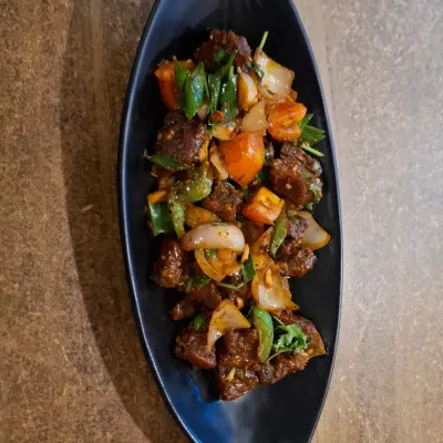 A Naga speciality, this is Pork Dry Fry with Axone. The fermented soybean gives it a unique, pungent flavour that is truly authentic to Nagaland.