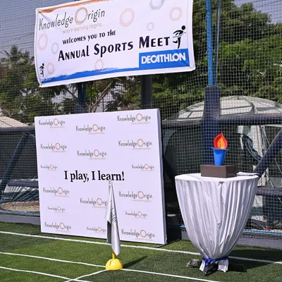 Our Annual Sports Meet is a highlight of the year. The event setup, complete with a banner and ceremonial torch, creates a sense of excitement and celebrates the children's physical achievements.