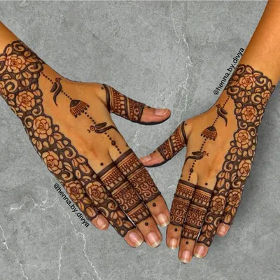 This design features a beautiful floral cuff and delicate hanging jhumka motifs. The pattern is a classic choice for wedding guests, offering a touch of tradition and elegance.