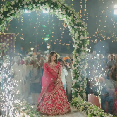 A bride's breathtaking entrance through an arch of flowers and sparklers. This is the beginning of her walk towards a new life, and we capture it with all the grandeur it deserves.