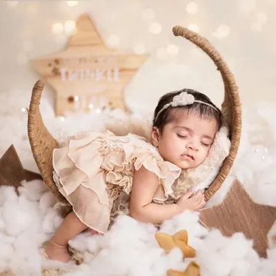 I love you to the moon and back. This dreamy newborn portrait features a sweet baby girl sleeping on a moon prop. I use soft fabrics and a starry background to create a magical and safe environment for your newborn.