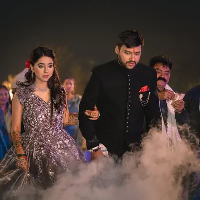 The grand entrance of the couple at their ring ceremony, walking through a dramatic cloud of smoke. This creates a truly cinematic start to the evening.