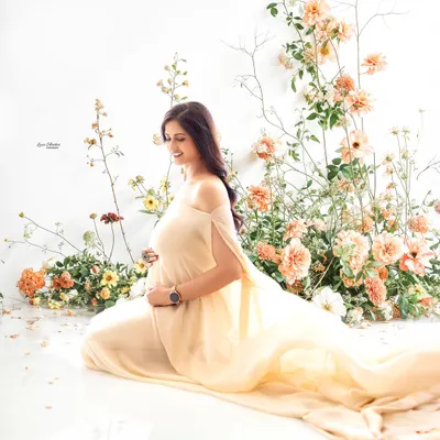 A moment of serene beauty. This portrait combines a simple, elegant gown with a stunning floral installation, creating a look that is both modern and timelessly romantic.