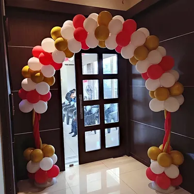 This classic balloon arch, in a vibrant red, white, and gold color scheme, is perfect for decorating an entrance. It serves as a cheerful welcome point for employees and guests during a corporate event or celebration.