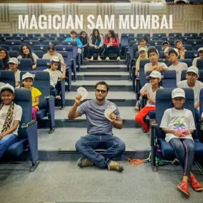 Posing for a photo after a magic workshop with a group of enthusiastic kids in an auditorium. It's always a joy to inspire the next generation of performers and magic lovers.