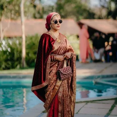 I just love how this entire look came together. The unique saree draping, paired with a velvet shawl and a stylish head wrap, creates a look that is both regal and incredibly chic.