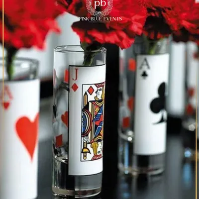 For a Diwali card party, I designed these unique centerpieces. Each vase features a different suit from a deck of cards, adding a playful and thematic detail to the table settings.