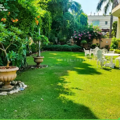 A beautiful, expansive lawn creating a peaceful retreat. We specialize in lawn installation and maintenance, ensuring a healthy, green carpet for your large garden spaces.