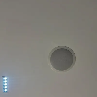 This close-up shows a Polk Audio RC60i in-ceiling speaker I installed as part of a complete home theater system. It delivers crisp overhead sound for Dolby Atmos effects while remaining almost invisible, maintaining a clean ceiling line.