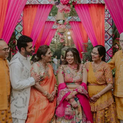 A beautiful, happy portrait of the couple with their parents. Capturing the joy of the two families coming together is one of the most important parts of our job.