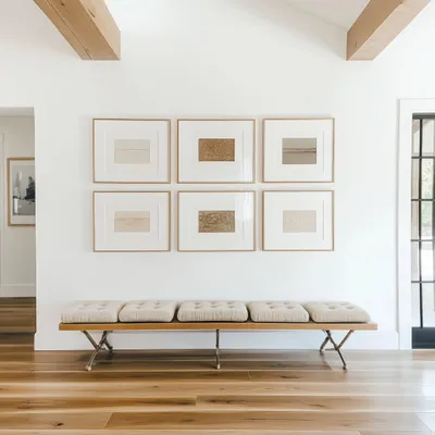 For a client's villa in Alibaug, we framed a beautiful set of six limited edition etching prints to create this bespoke gallery wall. The natural veneer wooden frames and wide white mats create a serene and sophisticated look.