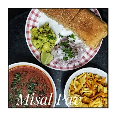 My homemade Misal Pav, a quintessential Maharashtrian breakfast and snack. It is served with spicy sprouted lentil curry, farsan, chopped onions, and soft pav, just the way it should be.