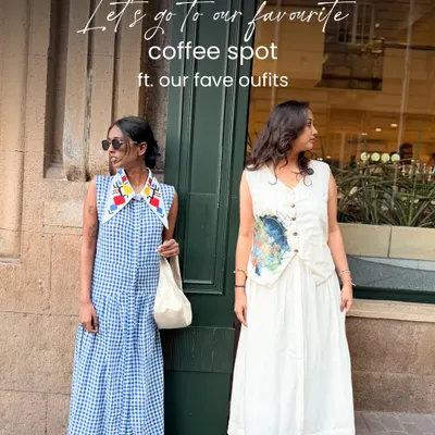 A coffee date featuring two of my favorite outfits. On the left, the Primary Gingham Maxi dress in handloom Bengal cotton with a hand-detailed art collar. On the right, the Reverie Co-ord Set in fine cotton linen, a perfect example of versatile, art-inspired dressing.