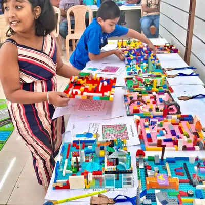Look at all those amazing finished projects! Kids proudly display their unique LEGO creations after a session of focused building and imagination. Each model tells a different story.