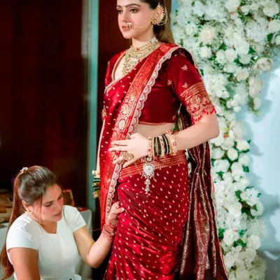 A behind the scenes moment where I am perfecting the pleats of a bride's red wedding saree. Every detail matters for a flawless finish.