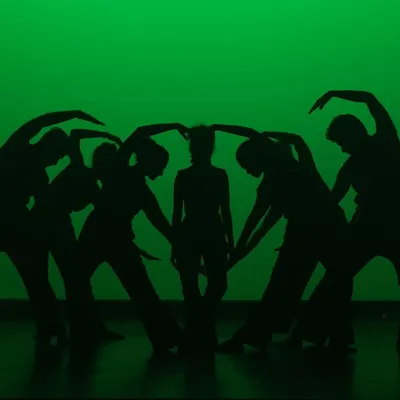 A creative silhouette formation by our contemporary dancers. We encourage artistic expression and teamwork to create visually stunning moments like this on stage.