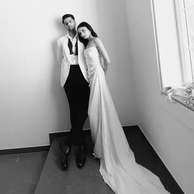 A high fashion, black and white portrait of Sahil and Khushali. The stark composition and their poses create a dramatic, magazine worthy image.