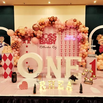 A setup fit for a boss. For this "Boss Baby" themed first birthday, we created a full stage with large marquee letters, character cutouts, and a detailed pink and rose gold balloon arrangement.