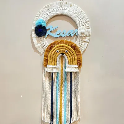 This personalized name hanging for Kesar features a brave lion rainbow design. The combination of the custom name, animal theme, and long colorful tassels makes it a standout piece for a nursery.