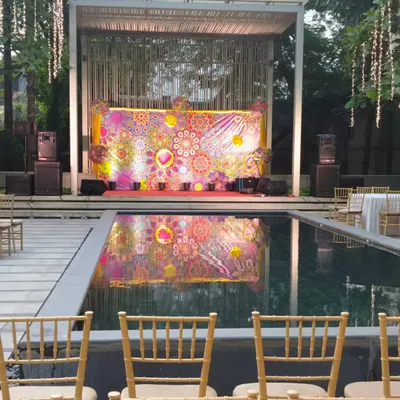 A stunning poolside stage for a corporate event. The colorful, abstract backdrop is reflected beautifully in the water, creating a high impact visual for presentations or performances.