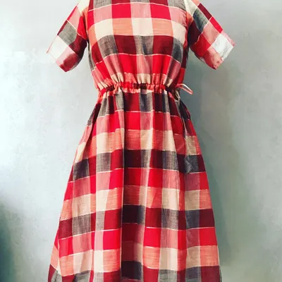 Your cotton sarees can become comfortable daily wear too. Here is a checkered saree turned into a stylish midi dress with an adjustable waist.