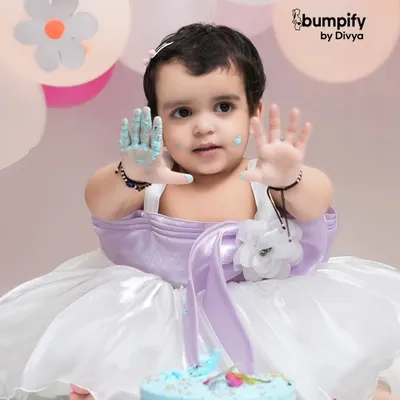 Look at my hands! This close up from a second birthday cake smash captures the messy, colorful fun perfectly. Her expression is absolutely priceless.