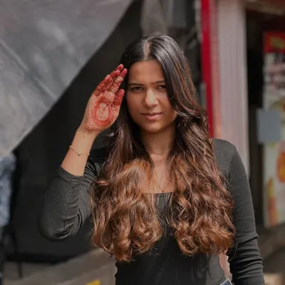 The beauty of balayage and a happy client. Her smile and confident pose say it all.