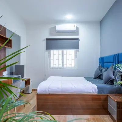 An overview of a finished room at Housr Nest, showing the bed with its custom fabric headboard, the integrated study area, and the overall minimalist design. This demonstrates our real-world execution of clean and efficient living spaces.