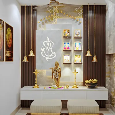 This is a beautiful fusion of modern materials. We used a dark fluted wood panel as a backdrop, contrasted with a white marble panel featuring a backlit Ganesha. Hanging brass bells and a sleek white console with drawers complete this elegant and functional pooja unit design.