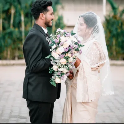 A romantic portrait of a Christian bride and groom sharing a quiet moment after their ceremony, bouquet in hand.