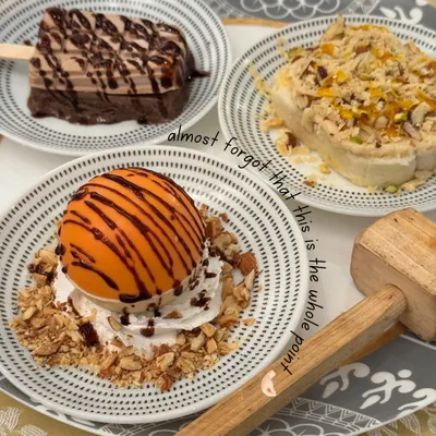 In the middle of all the wedding madness, don't forget the main point. This stunning plate of desserts, featuring a chocolate dome, kulfi, and more, is a reminder that food is the celebration.
