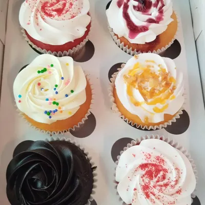 A box of our happiness, featuring an assortment of our most popular cupcake flavors like red velvet, chocolate, and vanilla blueberry. Perfect for any office occasion.