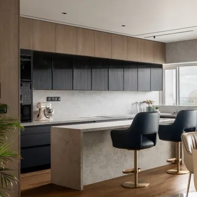 This show kitchen in our Kolkata project features a mix of wood and fluted black cabinetry for a modern, textured look. The large island with a stone finish provides ample workspace and seating, connecting the kitchen seamlessly to the living and dining areas.