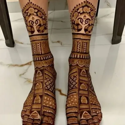 A stunning full-coverage bridal foot design with peacock motifs. This design is intricate and covers the feet beautifully, perfect for a bride.