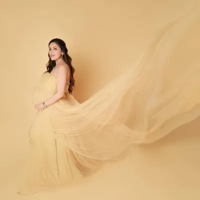 For the mamas who want to feel like a queen, a flowing gown session is pure magic. The way the fabric catches the air feels like we are capturing a dream.